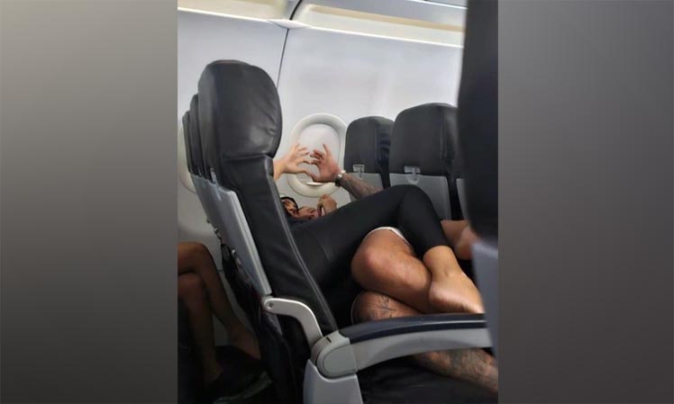 Couple PDA In The Flight, Public Display Of Affection, Couple Viral Photos, Couple Laying Hugged, Ajab Gajab News, Viral News, OMG News, Interesting Stories,
